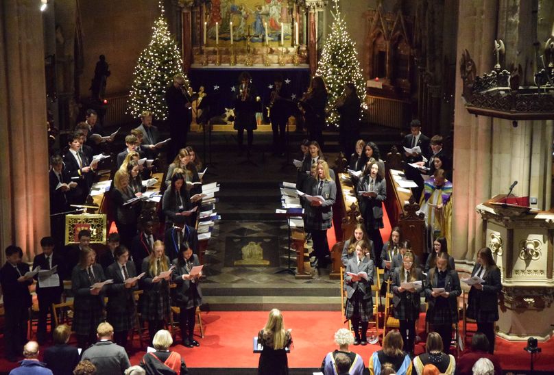 HSD's Festival Of Nine Lessons And Carols. Pupils and staff in church singing carols and hymns in ceremony celebrating Christmas.