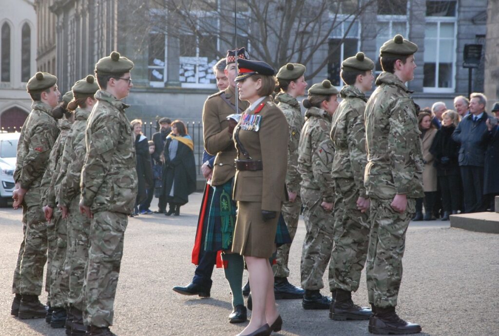 The High School of Dundee has celebrated a very special anniversary for its Combined Cadet Force. Cadets standing in uniform and in line on court yard, with army personnel directing them. Staff, parents and associates spectating at the side.